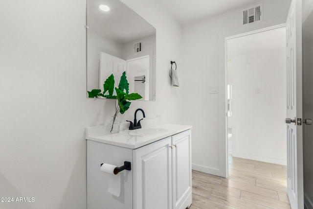 bathroom featuring vanity and hardwood / wood-style flooring