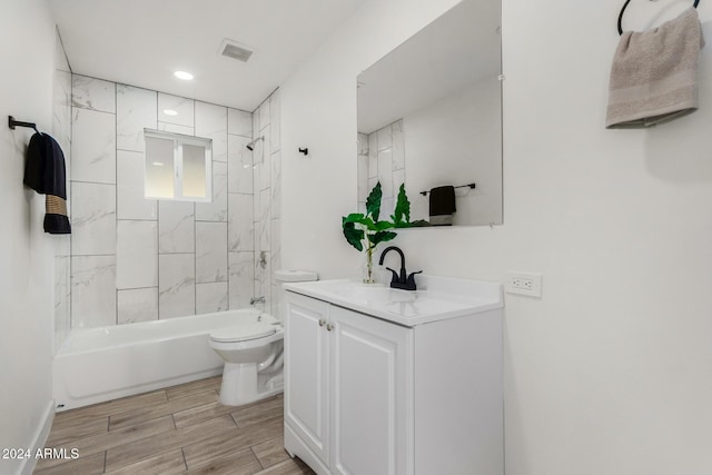 full bathroom with tiled shower / bath combo, toilet, and vanity