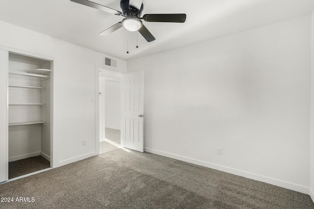 unfurnished bedroom with carpet flooring, ceiling fan, and a closet