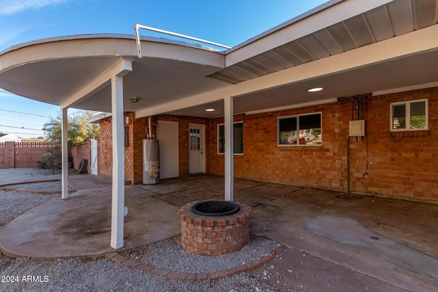 view of patio / terrace featuring an outdoor fire pit and water heater