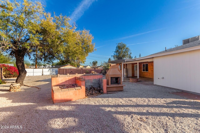 view of yard with a fireplace and a patio