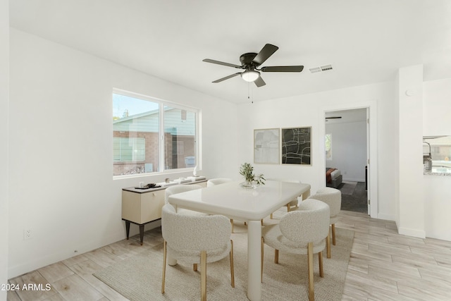 dining area with light hardwood / wood-style flooring and ceiling fan