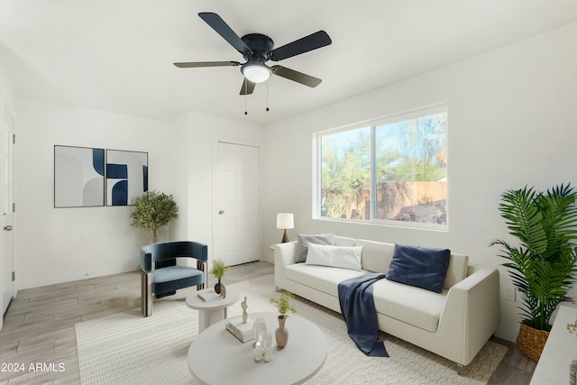 living room with ceiling fan and light hardwood / wood-style floors