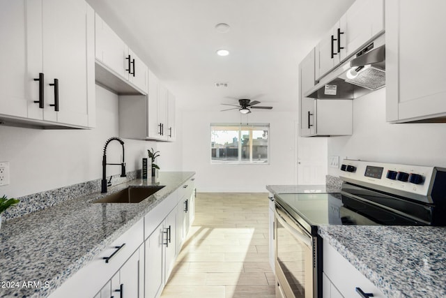 kitchen featuring white cabinetry, stainless steel electric range oven, ceiling fan, and sink