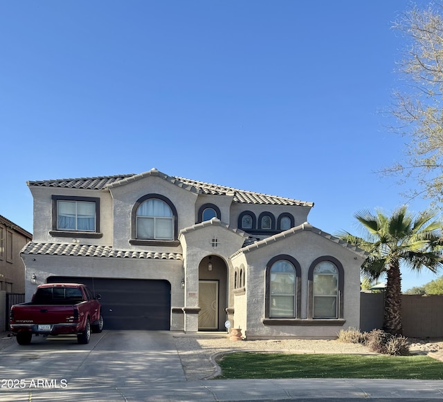 9108 W Kirby Ave, Tolleson, AZ 85353 - mediterranean / spanish house featuring an attached garage, a tiled roof, driveway, and stucco siding