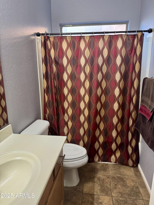 9108 W Kirby Ave, Tolleson, AZ 85353 - bathroom with toilet, a healthy amount of sunlight, a textured wall, and vanity