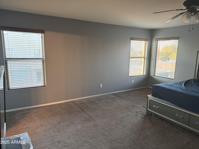9108 W Kirby Ave, Tolleson, AZ 85353 - bedroom with baseboards, dark carpet, and a ceiling fan