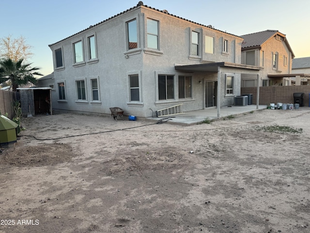 9108 W Kirby Ave, Tolleson, AZ 85353 - rear view of house with central air condition unit, a patio, stucco siding, and fence