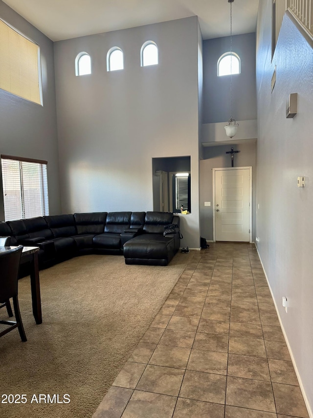 9108 W Kirby Ave, Tolleson, AZ 85353 - living area featuring baseboards, tile patterned flooring, and a towering ceiling