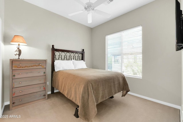 bedroom featuring a ceiling fan, visible vents, baseboards, and carpet flooring