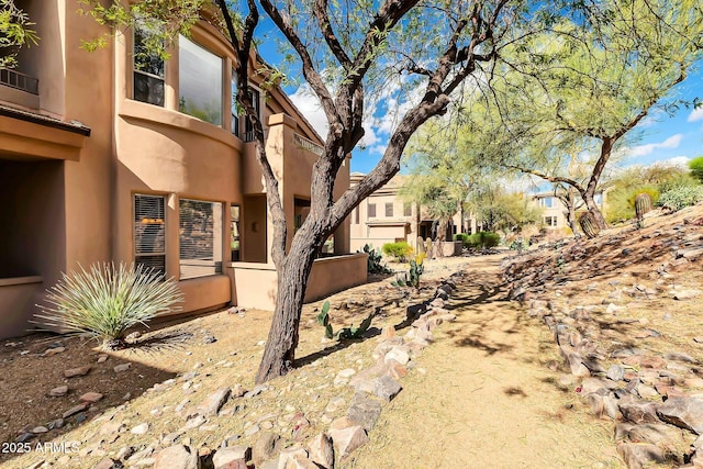 view of side of property with stucco siding