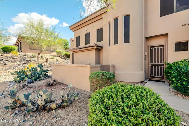 doorway to property with stucco siding