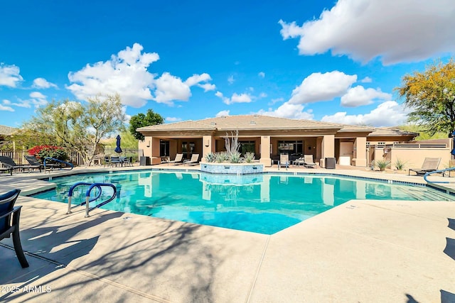 pool with a patio and fence