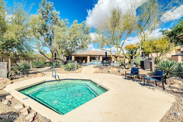 view of pool featuring a patio area and fence