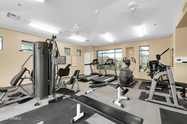 gym with visible vents, ceiling fan, and baseboards