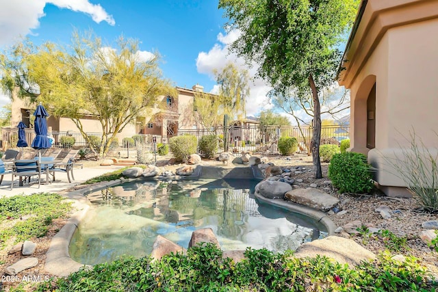 view of swimming pool with fence and a patio