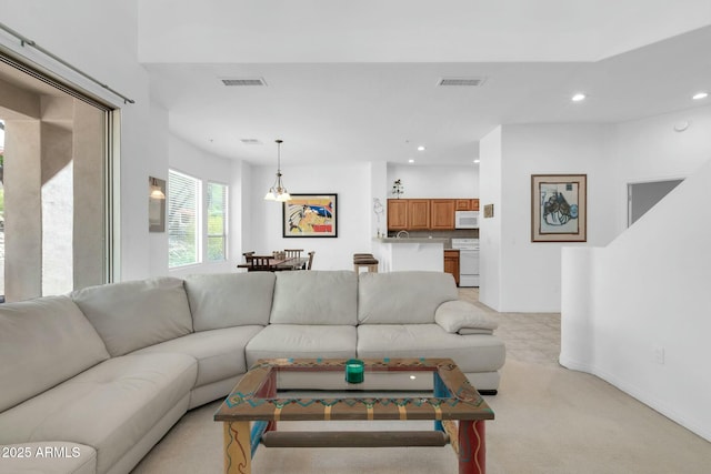 living room featuring light colored carpet, visible vents, and recessed lighting