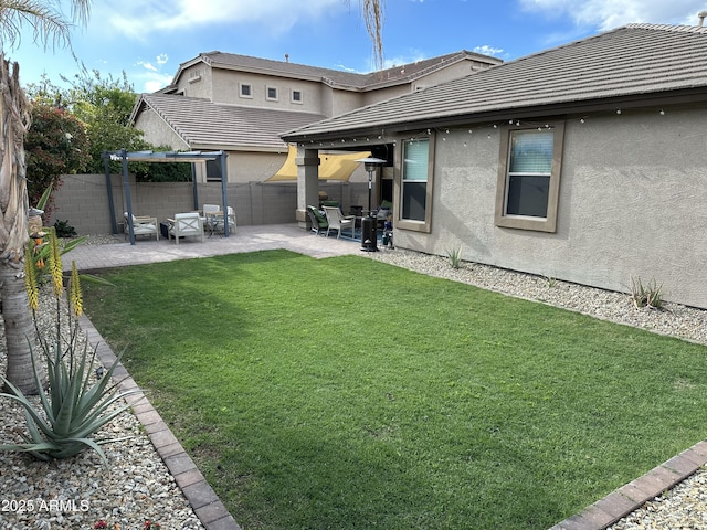 rear view of property featuring a tiled roof, a patio area, and stucco siding