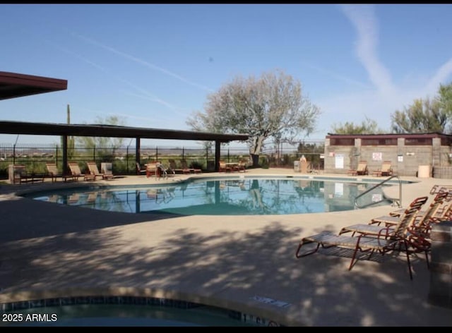 pool featuring a patio and fence