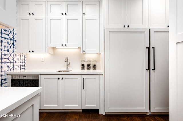 kitchen featuring sink, dark wood-type flooring, and white cabinets