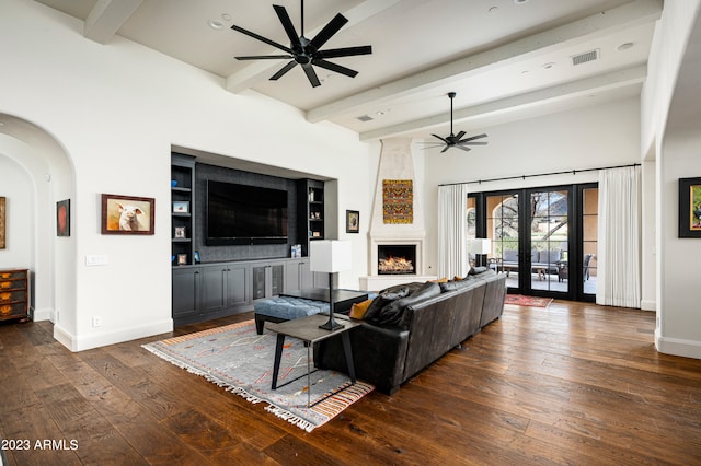 living room with ceiling fan, beamed ceiling, french doors, a fireplace, and dark hardwood / wood-style flooring