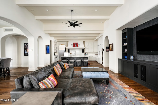 living room featuring beam ceiling and dark wood-type flooring