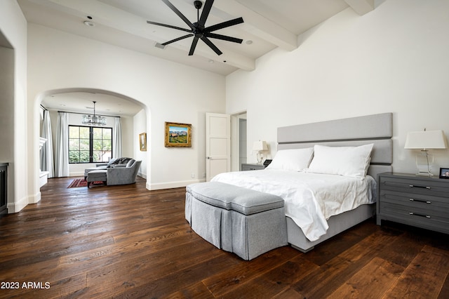 bedroom featuring ceiling fan with notable chandelier, dark hardwood / wood-style floors, beam ceiling, and high vaulted ceiling