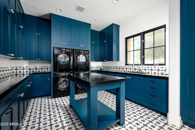 laundry area with cabinets and sink