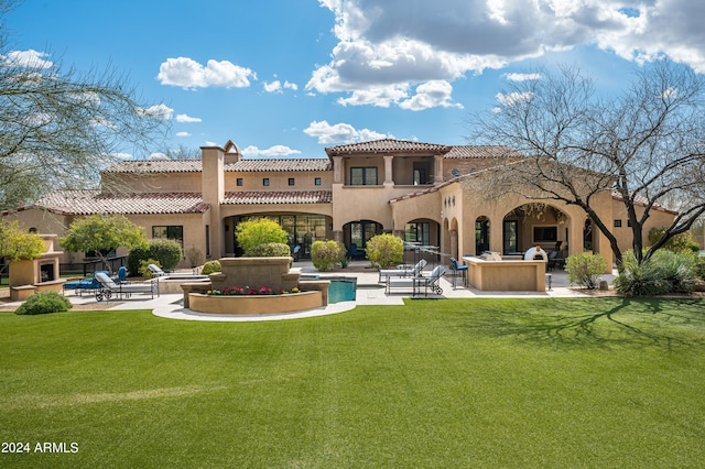 rear view of property featuring a yard and a patio area