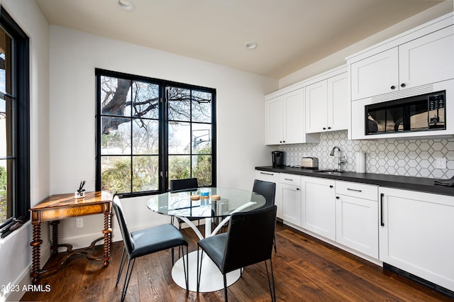 kitchen featuring dark hardwood / wood-style floors, black microwave, and a wealth of natural light