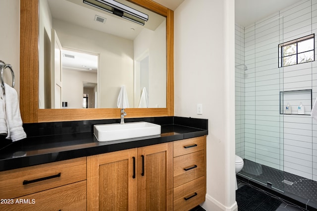 bathroom featuring walk in shower, vanity, toilet, and tile patterned floors