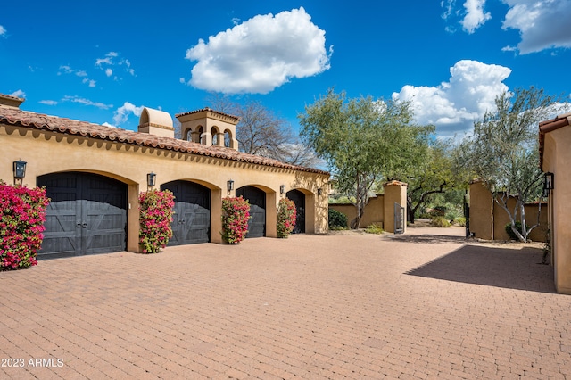 mediterranean / spanish house with a garage