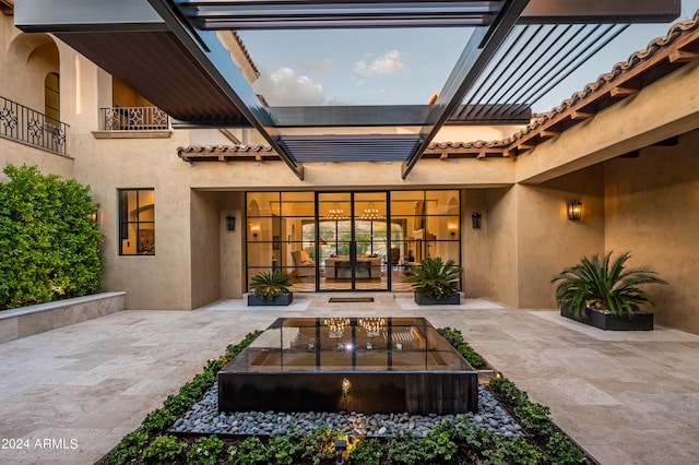 view of patio / terrace with a balcony and french doors