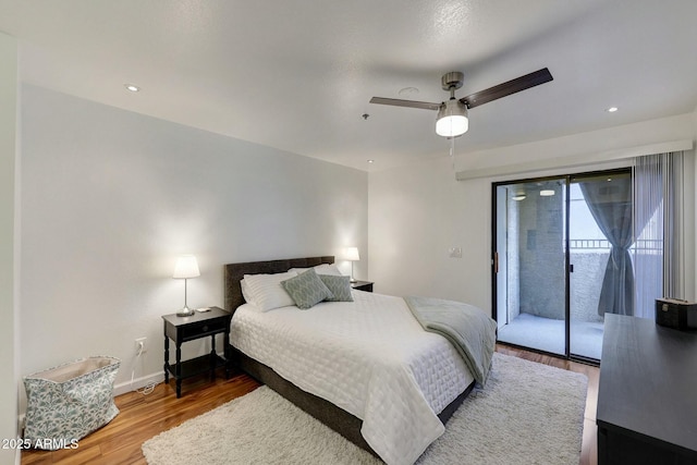 bedroom with recessed lighting, wood finished floors, a ceiling fan, baseboards, and access to exterior