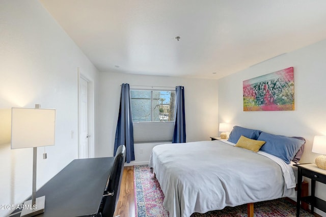 bedroom featuring wood finished floors