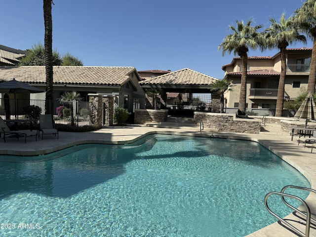 pool featuring a gazebo, a patio area, and fence