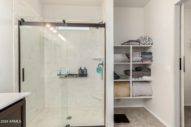 bathroom with tile patterned flooring, vanity, and an enclosed shower