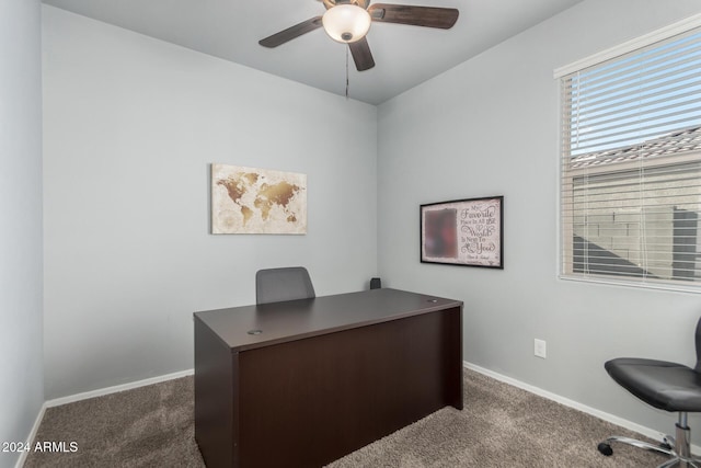 carpeted office featuring ceiling fan