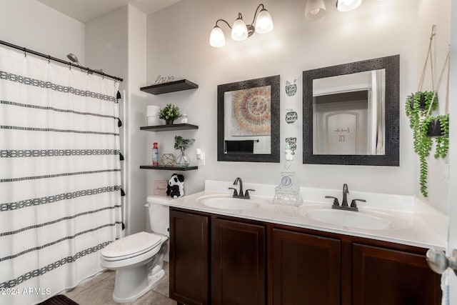 bathroom featuring toilet, vanity, and tile patterned floors