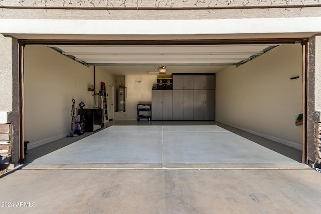 garage featuring a garage door opener, a carport, and water heater