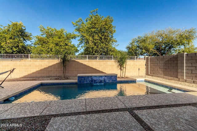 view of swimming pool with pool water feature