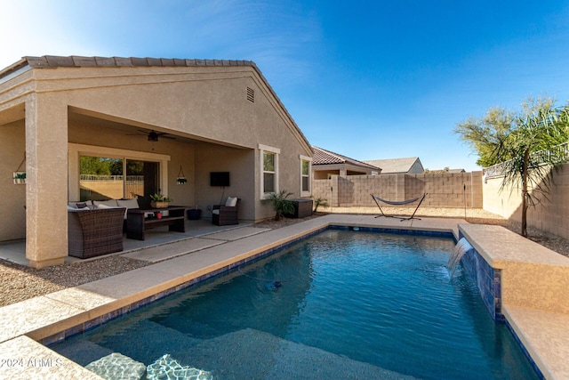 view of swimming pool featuring pool water feature, ceiling fan, an outdoor hangout area, and a patio