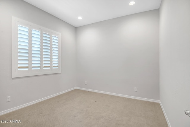 carpeted spare room featuring recessed lighting and baseboards