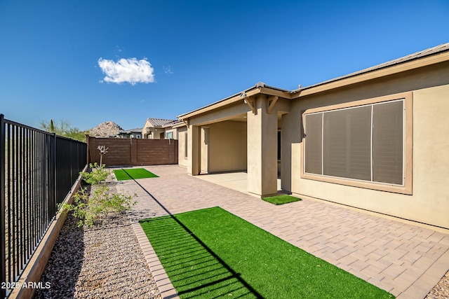 view of yard with a patio area and a fenced backyard