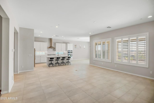 unfurnished living room featuring recessed lighting, visible vents, baseboards, and light tile patterned flooring