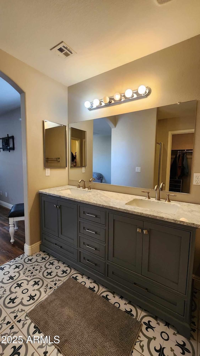 bathroom with tile patterned flooring and vanity