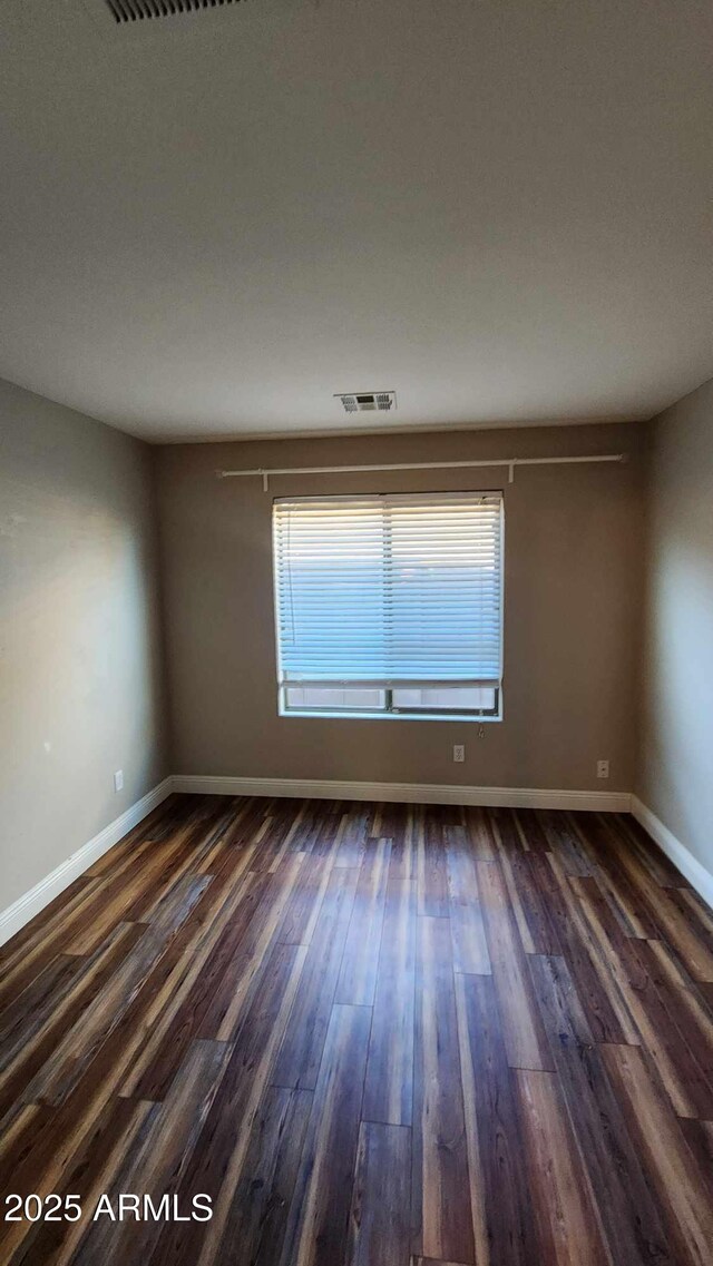 empty room with dark wood-type flooring