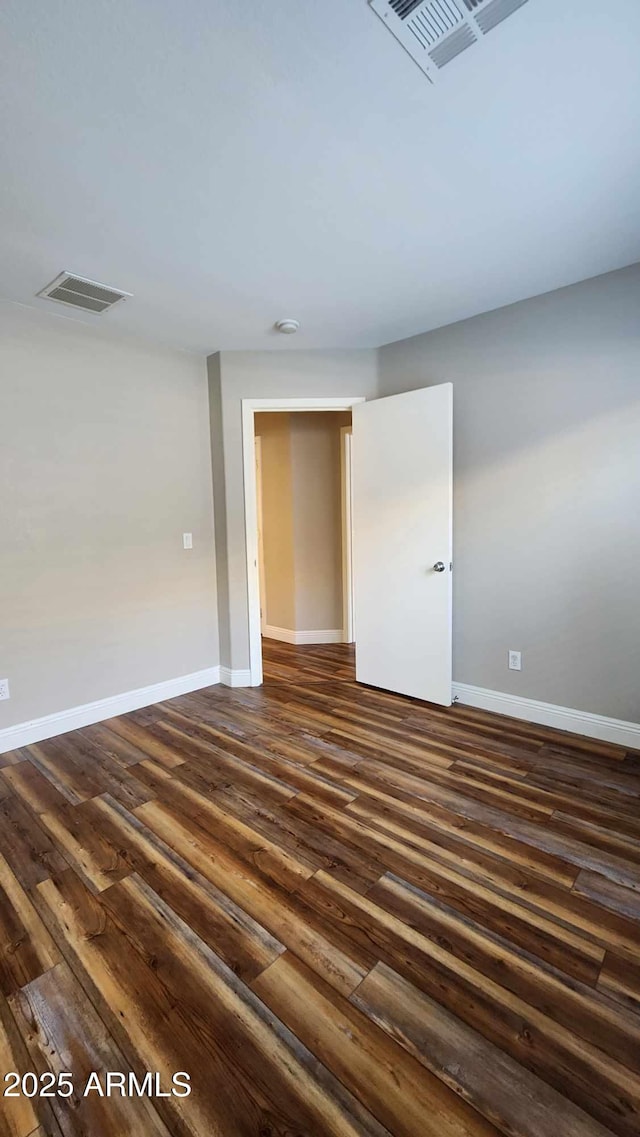 empty room featuring dark wood-type flooring