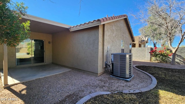 view of home's exterior with a patio and central AC