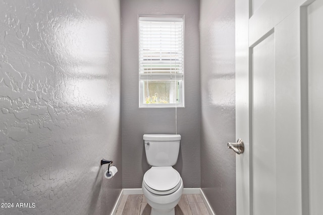 bathroom featuring hardwood / wood-style floors and toilet